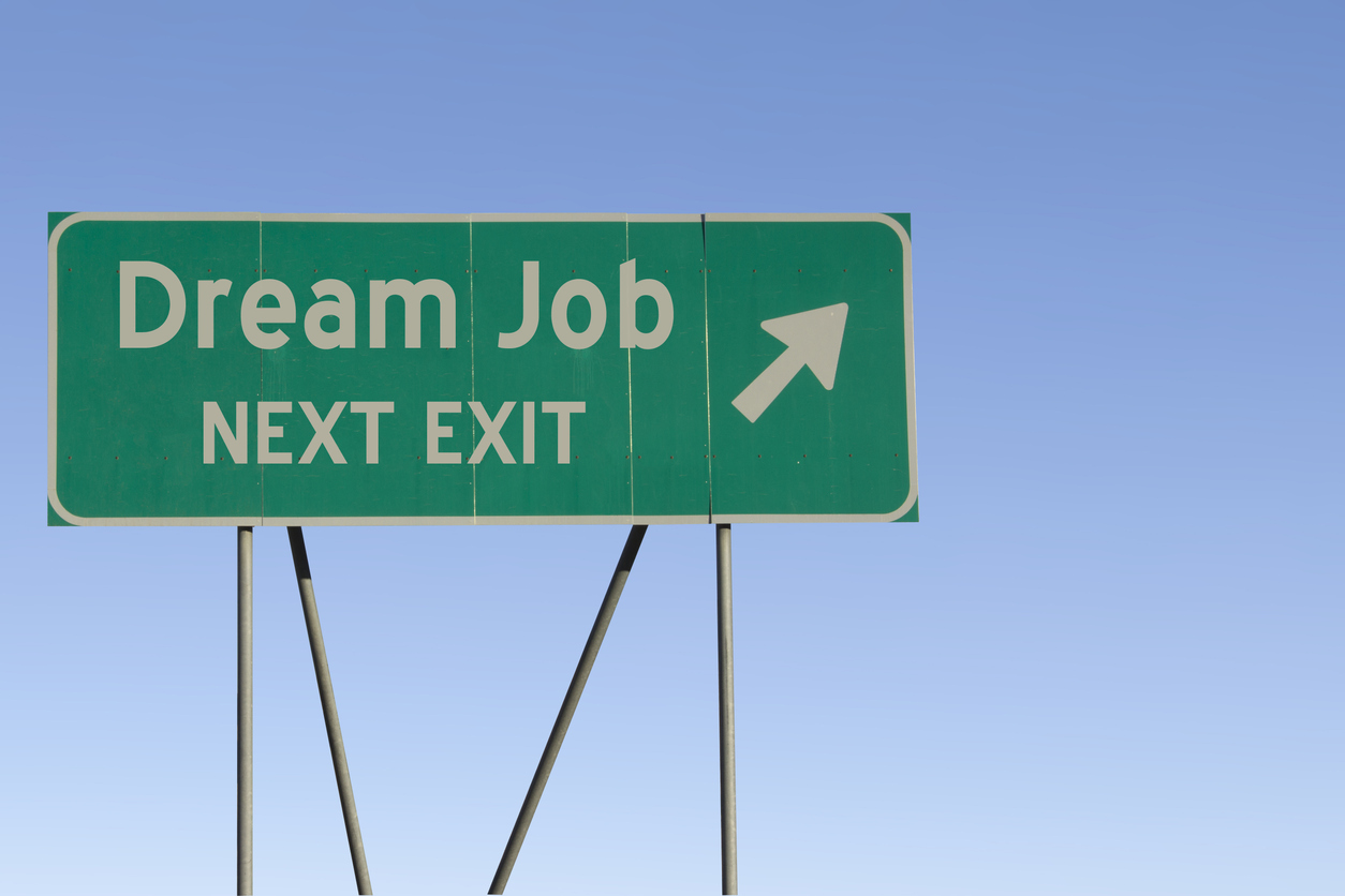 Next exit road sign leads to dream job, influenced by tech hiring trends.