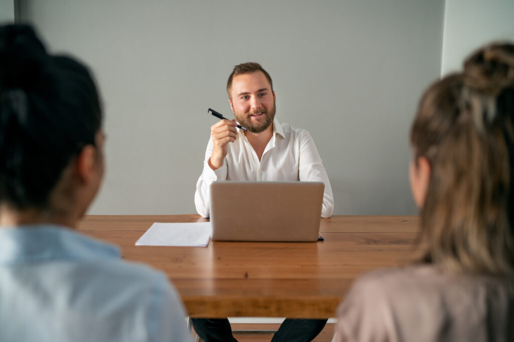 A job candidate confidently answers the top job interview questions.