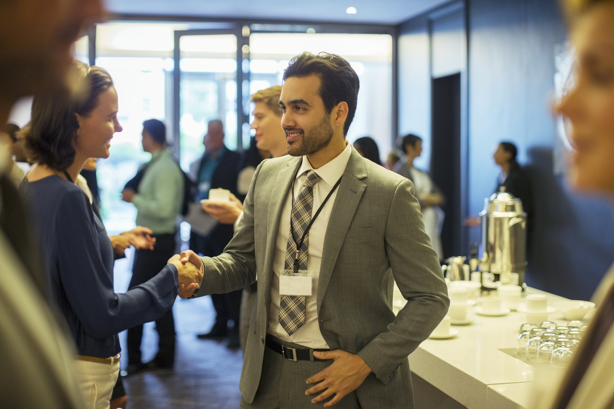 People shaking hands at a networking event.
