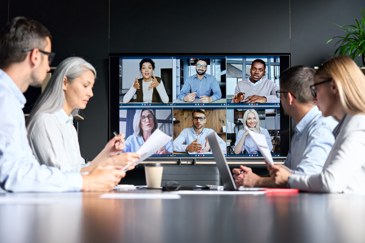 A project-based IT team meets virtually with offshore and in-person team.