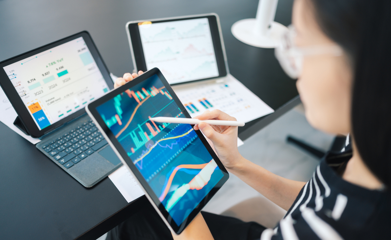 Manager looks at metrics on a tablet to measure AI success.