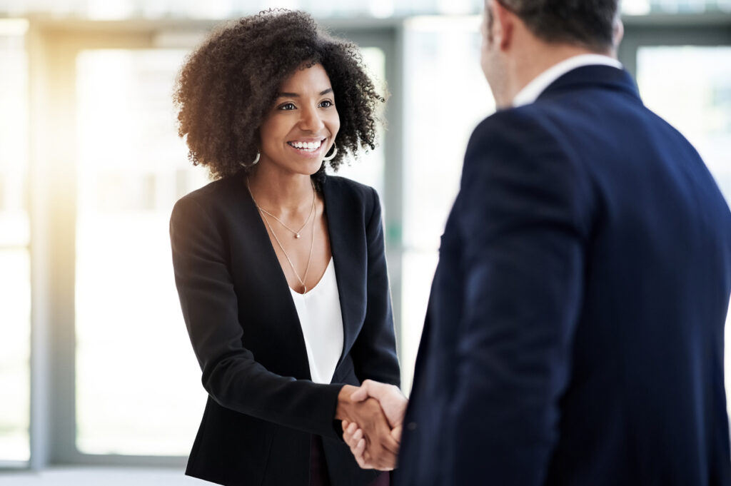 An IT manager welcomes a new hire after an effective IT hiring process.