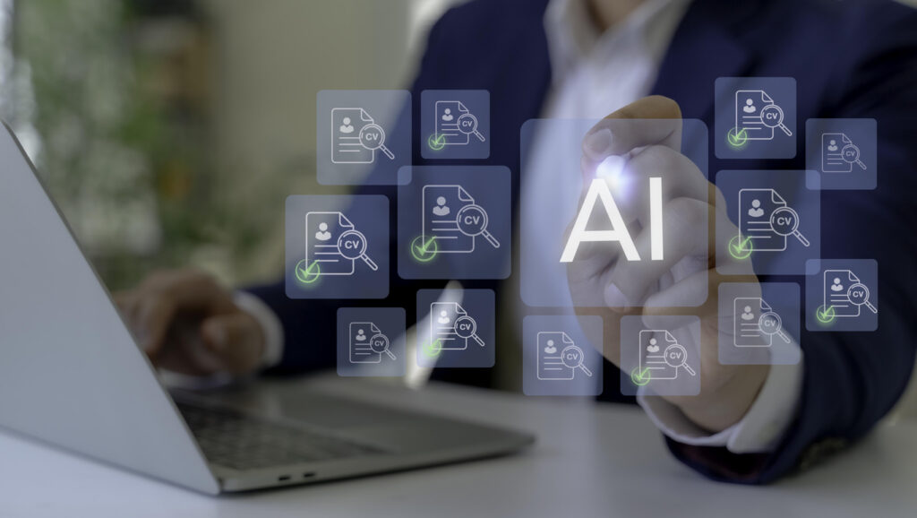 Hiring manager checks resumes online as part of the recruiting process while identifying fake AI candidates.