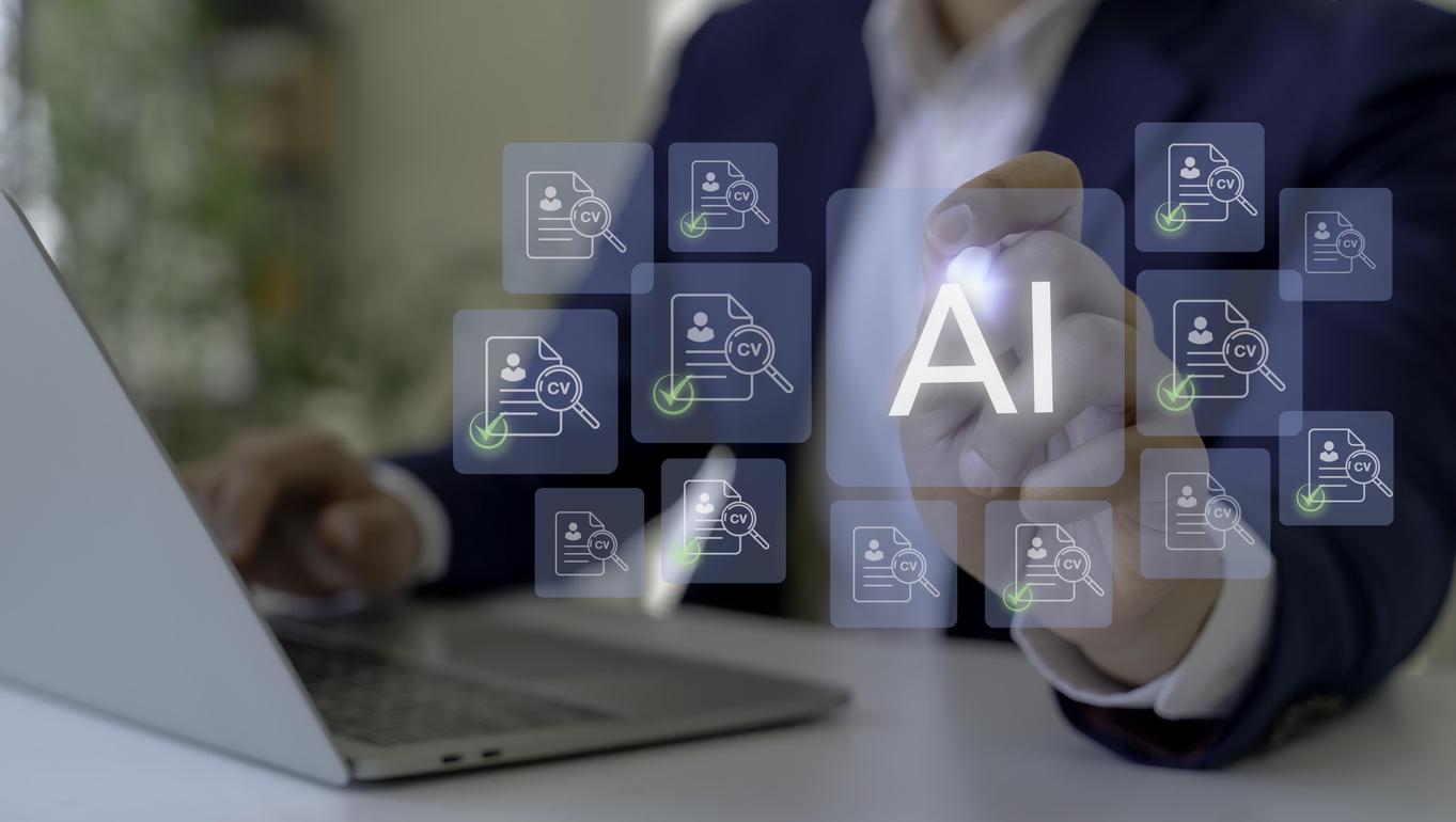 Hiring manager checks resumes online as part of the recruiting process while identifying fake AI candidates.